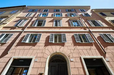 a tall brick building with windows and a door at Central Suite Navona Campo de Fiori IREX Apartment in Rome