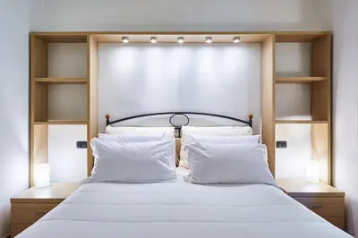 a bedroom with a white bed and a window at Central Suite Navona Campo de Fiori IREX Apartment in Rome