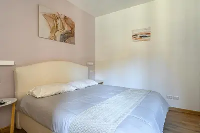a bedroom with a large bed with white sheets at Casa Camilla al Vaticano in Rome
