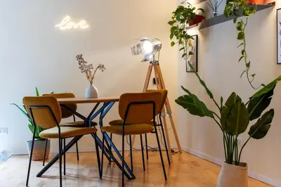 a table and chairs in a room with plants at Cantoni 4A - Loft at Colosseum in Rome