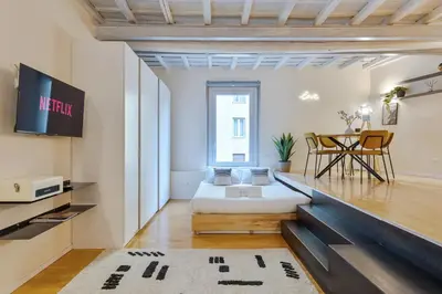 a living room with a bed and a table at Cantoni 4A - Loft at Colosseum in Rome