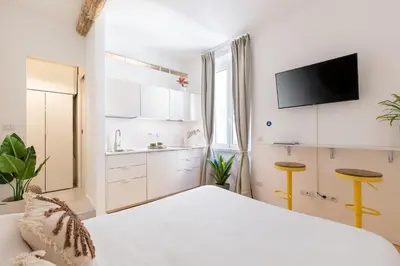 a bedroom with a bed and a sink and a tv at Cantoni 4B - Studio at Colosseum in Rome