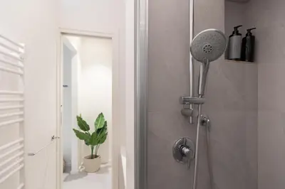 a shower with a shower head in a bathroom at Cantoni 4B - Studio at Colosseum in Rome