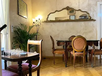 a chess table with two chairs and a chess board on it at SorinaHome Campo de Fiori Apartament in Rome