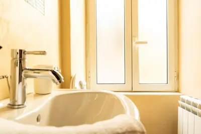 a white sink in a bathroom with a window at SorinaHome Campo de Fiori Apartament in Rome