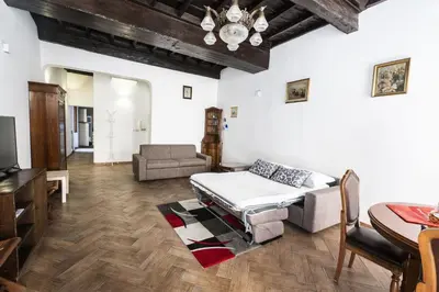 a living room with a bed and a table at Campo de Fiori Large Family Apartment in Rome