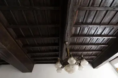 a chandelier hanging from a wooden ceiling at Campo de Fiori Large Family Apartment in Rome