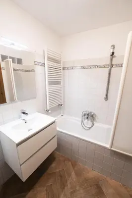 a bathroom with a white tub and a sink and a bath tubermott at Campo de Fiori Large Family Apartment in Rome