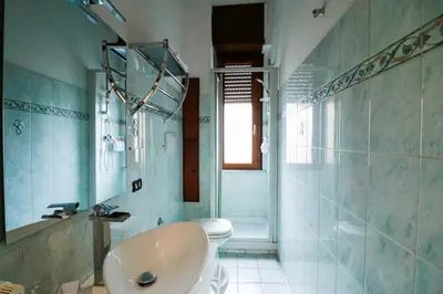 a bathroom with a toilet and a sink and a shower at Casa Angelina - Appartamento zona SanGiovanni in Rome