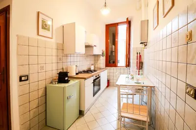 a kitchen with a green refrigerator and a table at Casa Angelina - Appartamento zona SanGiovanni in Rome