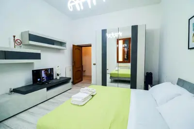 a bedroom with a bed and a tv and a mirror at Casa Angelina - Appartamento zona SanGiovanni in Rome