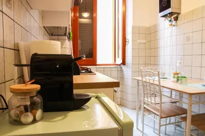 a kitchen with a counter with a coffee maker on it at Casa Angelina - Appartamento zona SanGiovanni in Rome
