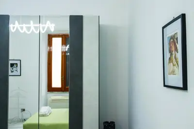 a mirror in a room with a bed at Casa Angelina - Appartamento zona SanGiovanni in Rome