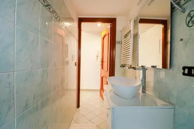 a bathroom with a tub and a sink and a mirror at Casa Angelina - Appartamento zona SanGiovanni in Rome