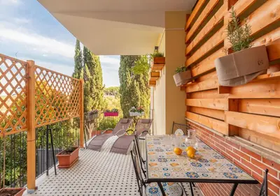 a patio with a table and chairs on a balcony at Vatican family loft in Rome