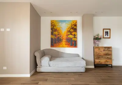 a couch in a room with a painting on the wall at Vatican family loft in Rome