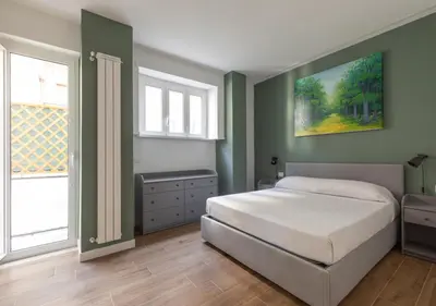 a bedroom with a bed and a painting on the wall at Vatican family loft in Rome