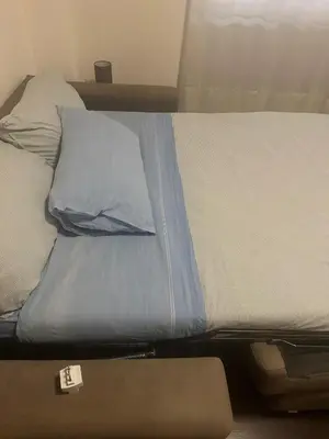 a bed with blue sheets and pillows on it at Aniene GH in Rome