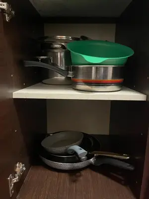 a kitchen shelf with a pot and pans on it at Aniene GH in Rome