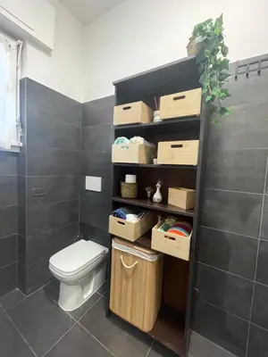 a bathroom with a toilet and boxes on the wall at Aniene GH in Rome