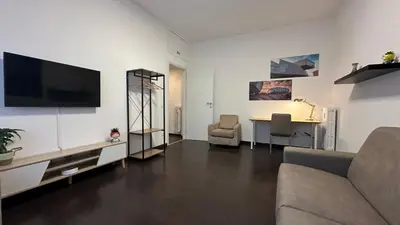 a living room with a couch and a desk at Aniene GH in Rome