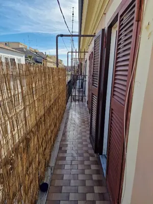 a walkway between two buildings with a fence at Appartamento-Castro Pretorio in Rome