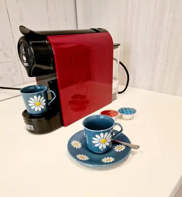 a coffee maker and two cups on a counter at Appartamento-Castro Pretorio in Rome