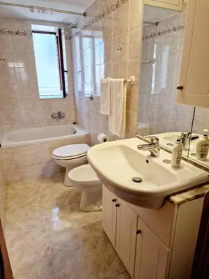 a bathroom with a sink and a toilet and a bath tub at Appartamento-Castro Pretorio in Rome