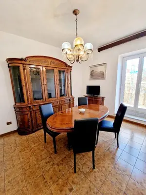 a dining room with a wooden table and chairs at Appartamento-Castro Pretorio in Rome