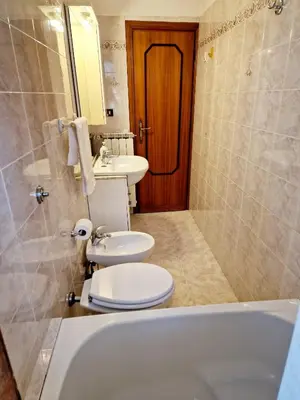 a bathroom with a tub and a toilet and a sink at Appartamento-Castro Pretorio in Rome