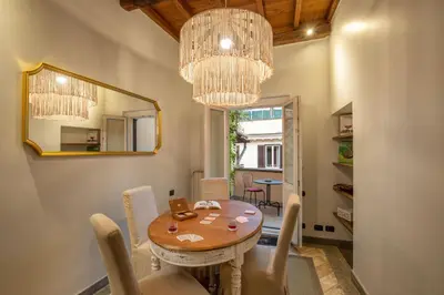 a dining room with a table and a mirror at Maison Medusa in Rome