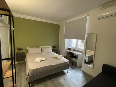 a bedroom with a bed with two towels on it at This must be the place Rome Guesthouse in Rome