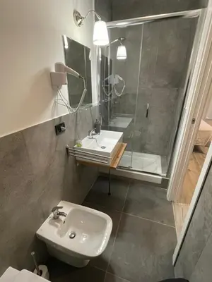 a bathroom with a sink and a shower at This must be the place Rome Guesthouse in Rome