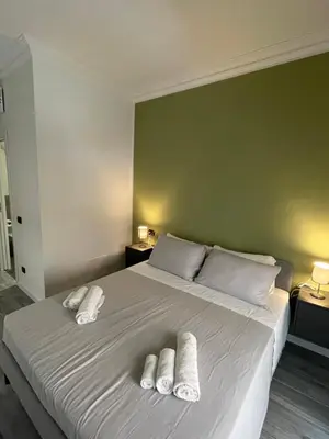 a bedroom with a bed with two towels on it at This must be the place Rome Guesthouse in Rome