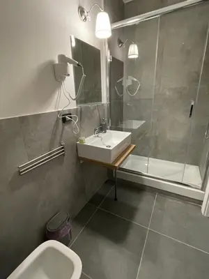 a bathroom with a sink and a shower and a toilet at This must be the place Rome Guesthouse in Rome