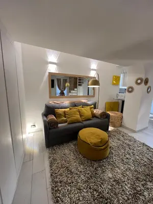 a living room with a couch and a rug at Loft a piazza di Spagna in Rome