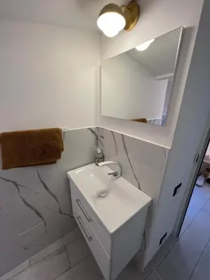 a white bathroom with a sink and a mirror at Loft a piazza di Spagna in Rome