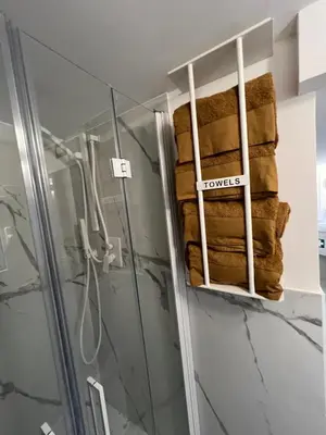 a bathroom with a shower and a stack of towels at Loft a piazza di Spagna in Rome