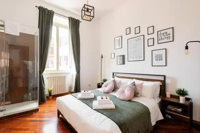 a bedroom with a bed with two towels on it at Piacentino Homes San Giovanni apartment in Rome