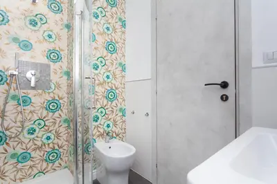 a bathroom with a shower with a toilet and a sink at Fiorini - Rooms in Rome