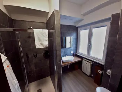 a bathroom with a sink and a shower at Piol Guest House in Rome