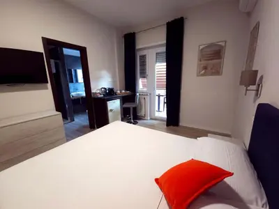 a bedroom with a bed with a red pillow on it at Piol Guest House in Rome