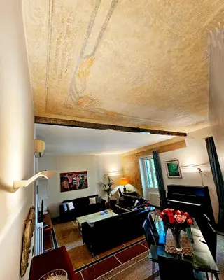 a living room with a leather couch and a piano at Vatican Prestige - Meospiti Cesare Exclusive in Rome