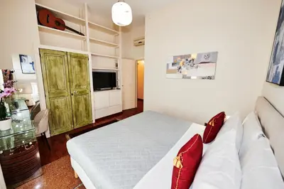 a bedroom with a white bed and a couch at Vatican Prestige - Meospiti Cesare Exclusive in Rome