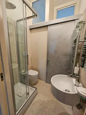 a bathroom with a shower and a sink and a toilet at Vatican Prestige - Meospiti Cesare Exclusive in Rome