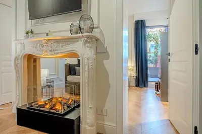 a fireplace in a living room with a fire place at Acque Romane Piazza di Spagna in Rome