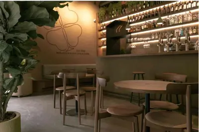 a restaurant with tables and stools in a room at Vita lenta Roma Pigneto terrazza in Rome