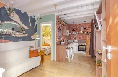a kitchen and living room with a couch in a room at Vita lenta Roma Pigneto terrazza in Rome