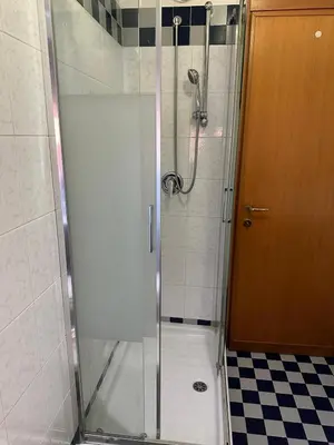 a shower with a glass door in a bathroom at Palm Rooms in Rome