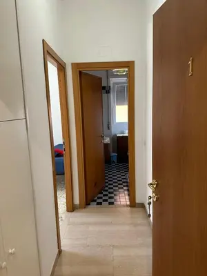 a hallway with a door open to a bathroom at Palm Rooms in Rome